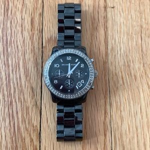 Michael Kors black metallic wristwatch. Needs new battery